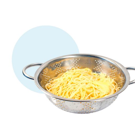 Freshly cooked pasta in a silver colander Freshly cooked pasta in a silver colander