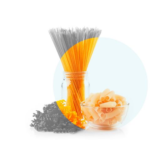 Bundle of uncooked standing spaghetti in a glass, next to it rigatoni in a bowl. Bundle of uncooked standing spaghetti in a glass, next to it rigatoni in a bowl.